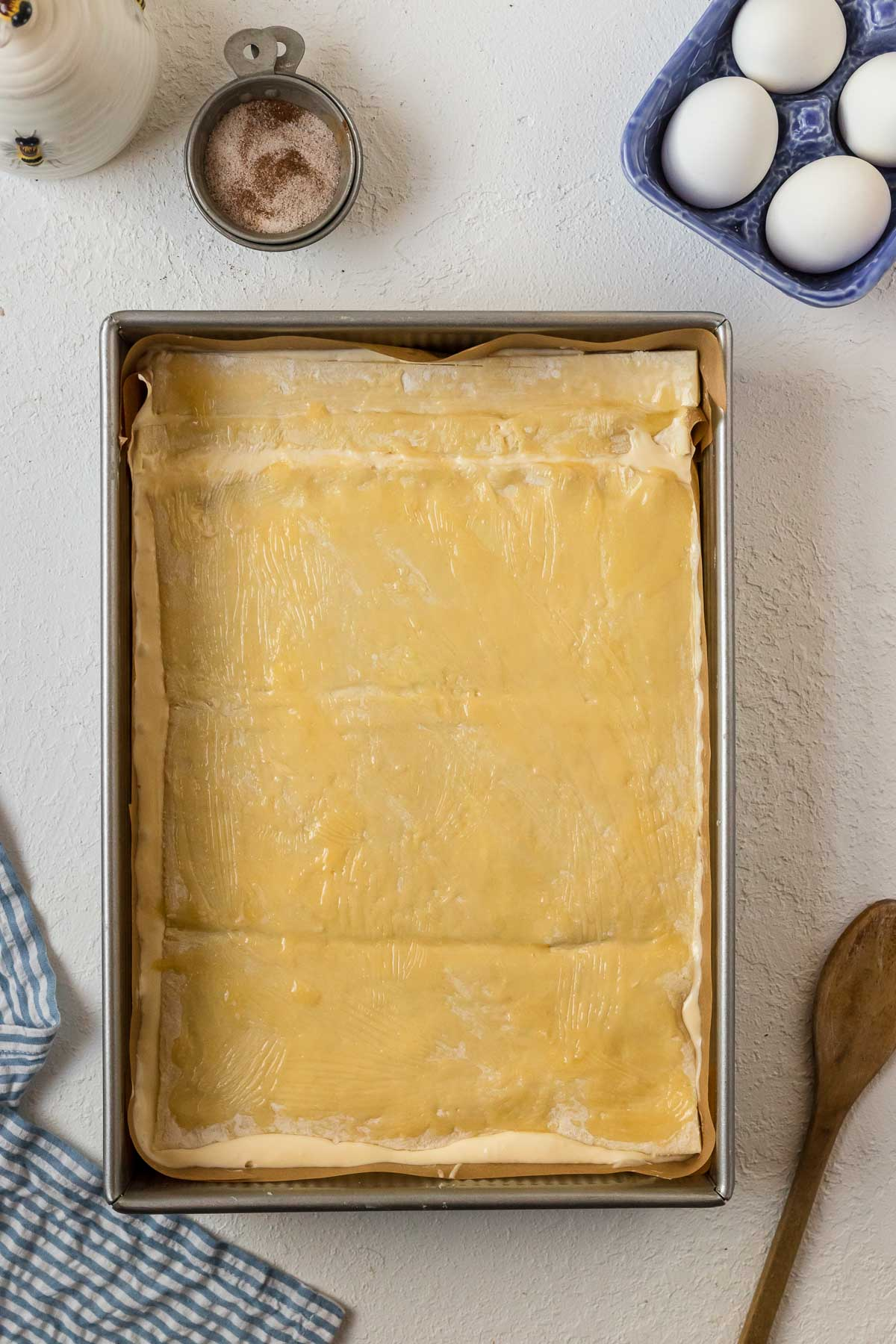 melted butter spread on top of puff pastry