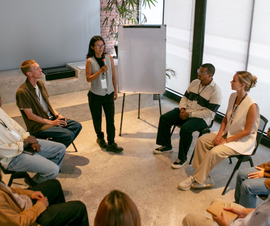 a woman leading the meeting agenda for her whole team on a positive note