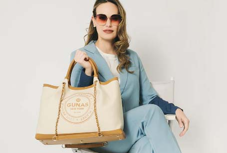 a professional business lady holding unique handmade GUNAS New York bag