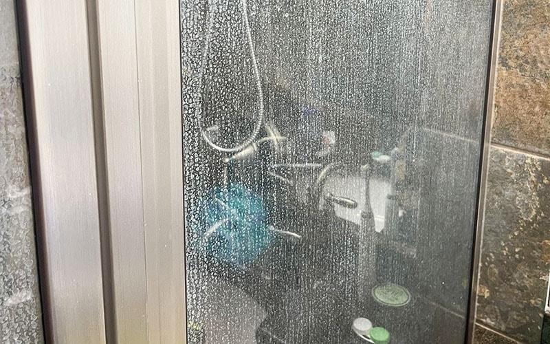 Hard water stains on shower glass door