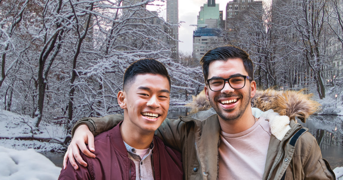 An image of a gay couple in Central Park in New York, NY holding each other happily after completing couples therapy.