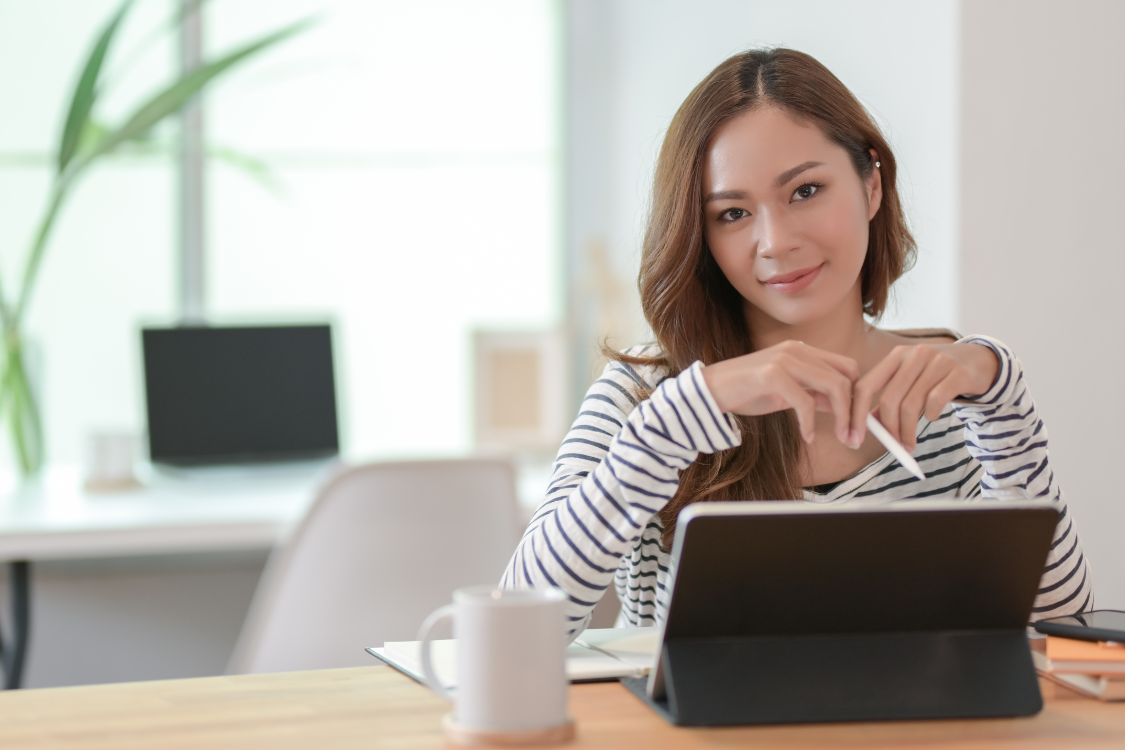 Filipino remote worker reviewing interview rubric on tablet