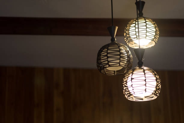 A caged style enclosed fixture with light bulbs. 