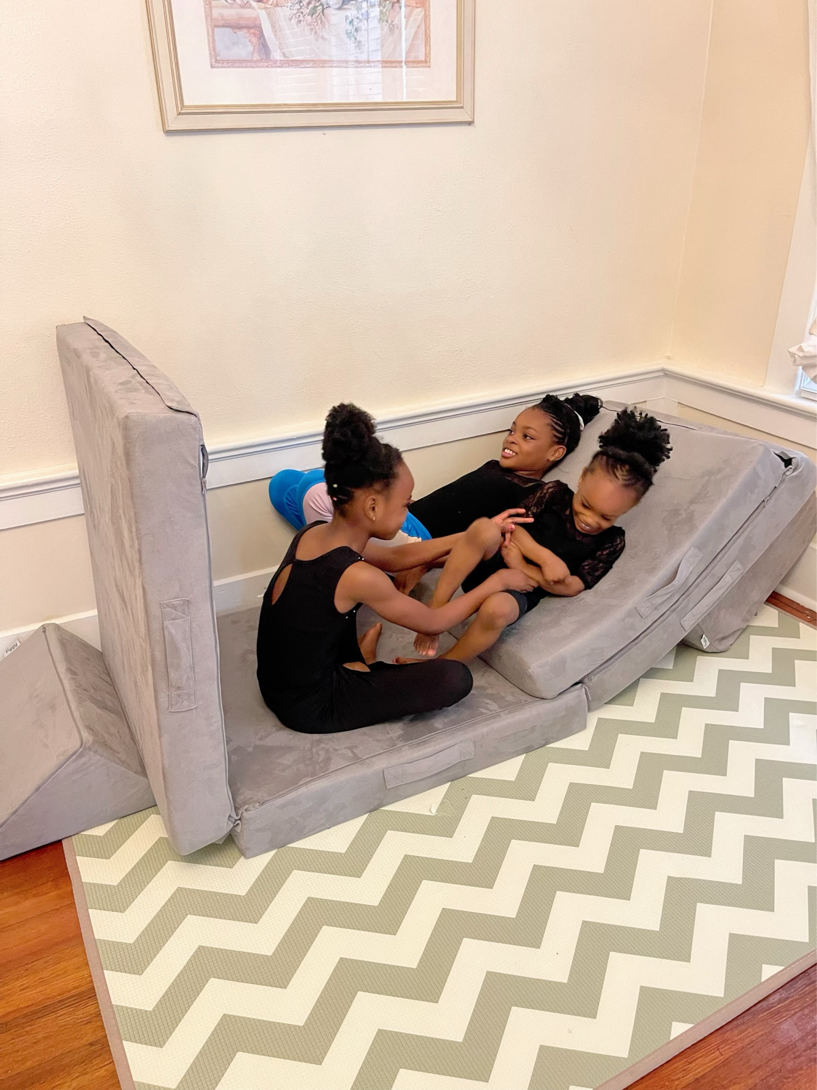 Children solving puzzles and building on a play couch