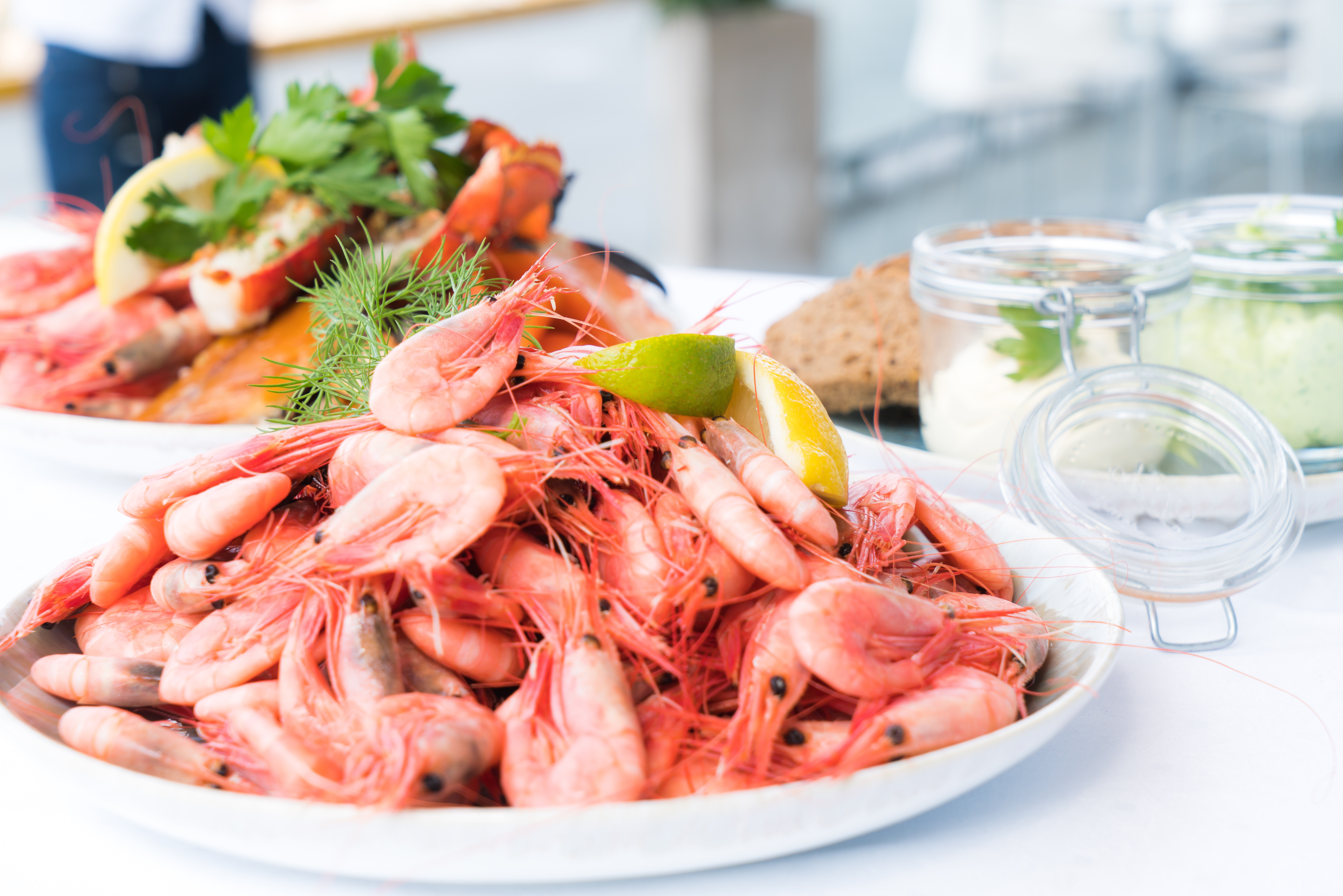 Image source: https://www.pexels.com/photo/boiled-shrimps-566344/    Caption: Shrimp on plate in restaurant