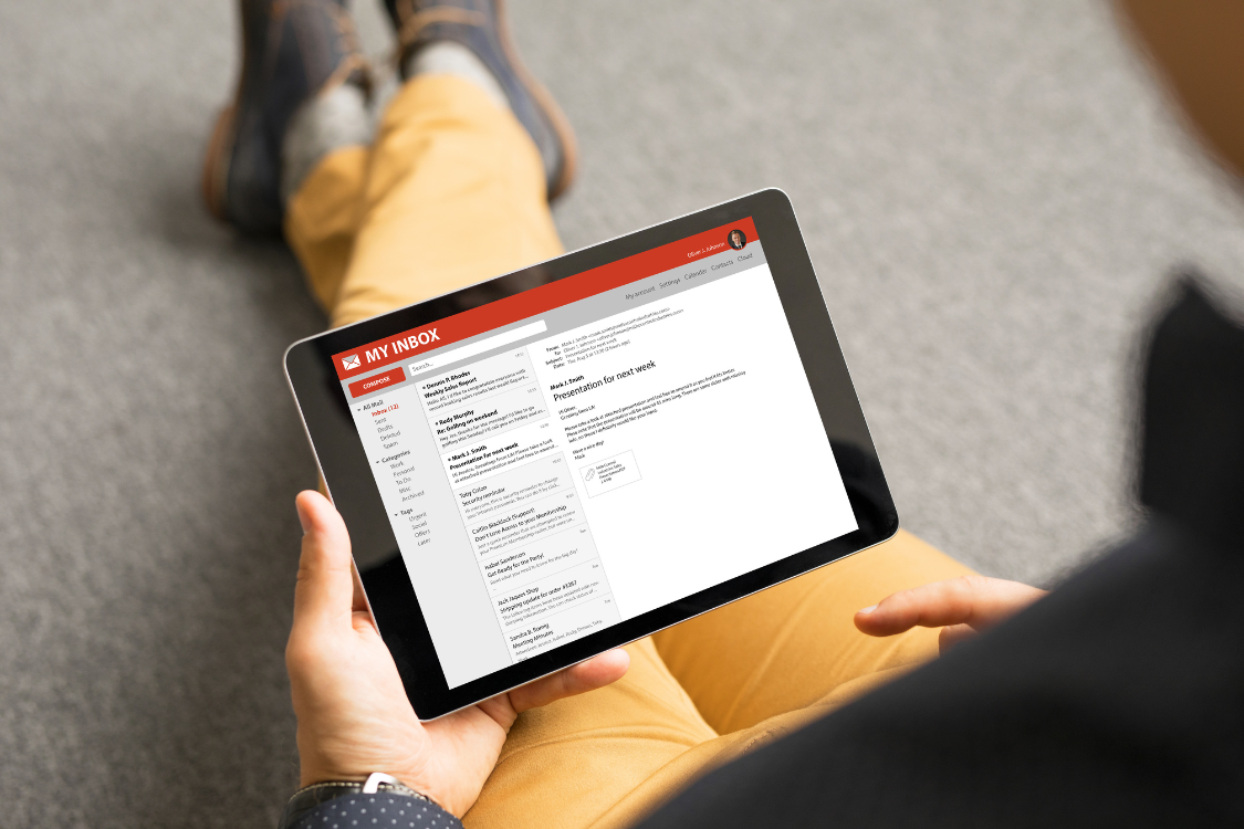Person reading email instructions or task updates on a tablet screen