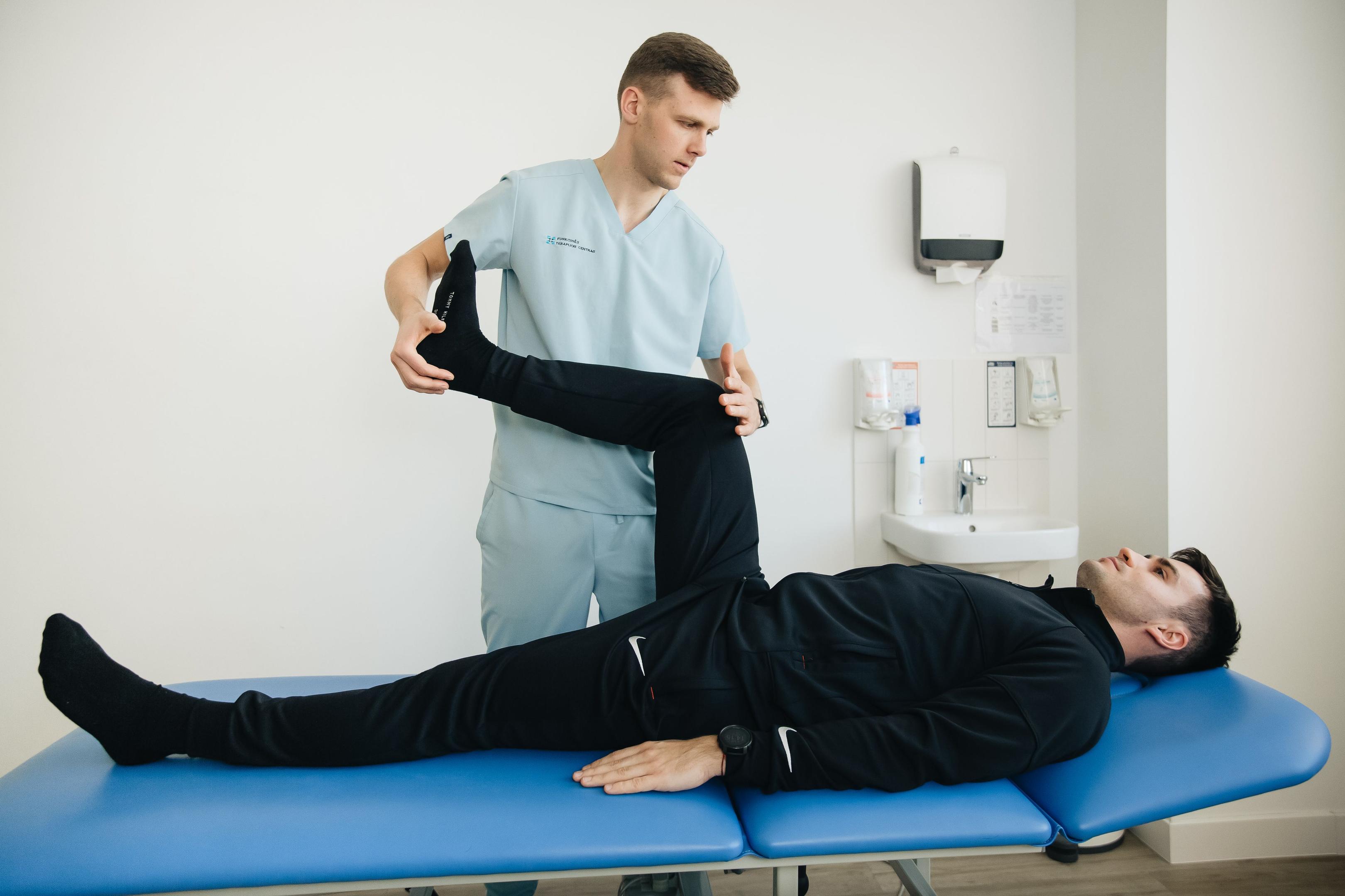 Sports medicine physical therapist treating leg injury to help athlete return to sport without surgery