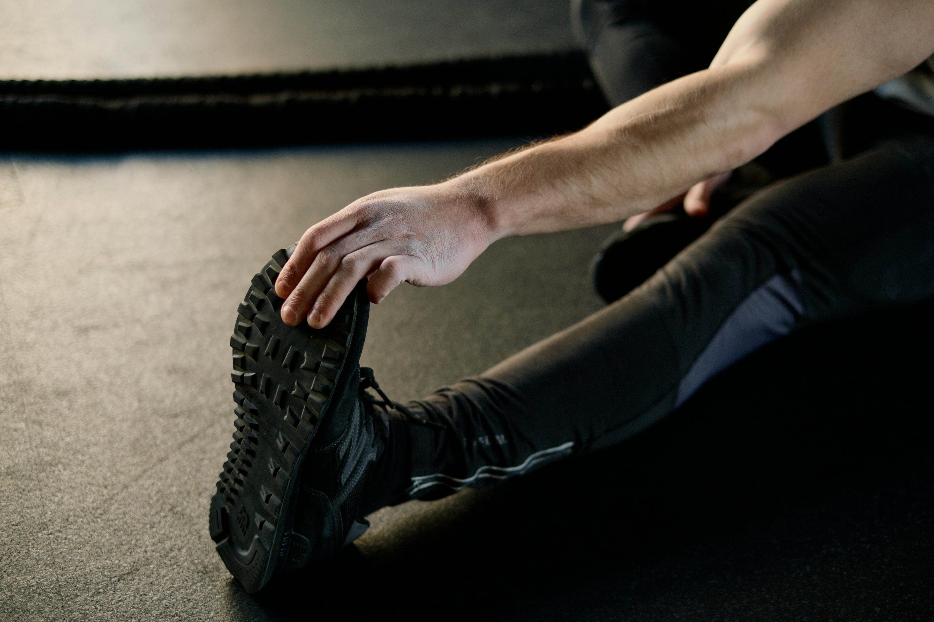 Photo by Ivan Samkov: https://www.pexels.com/photo/person-holding-his-foot-and-stretching-4164757/