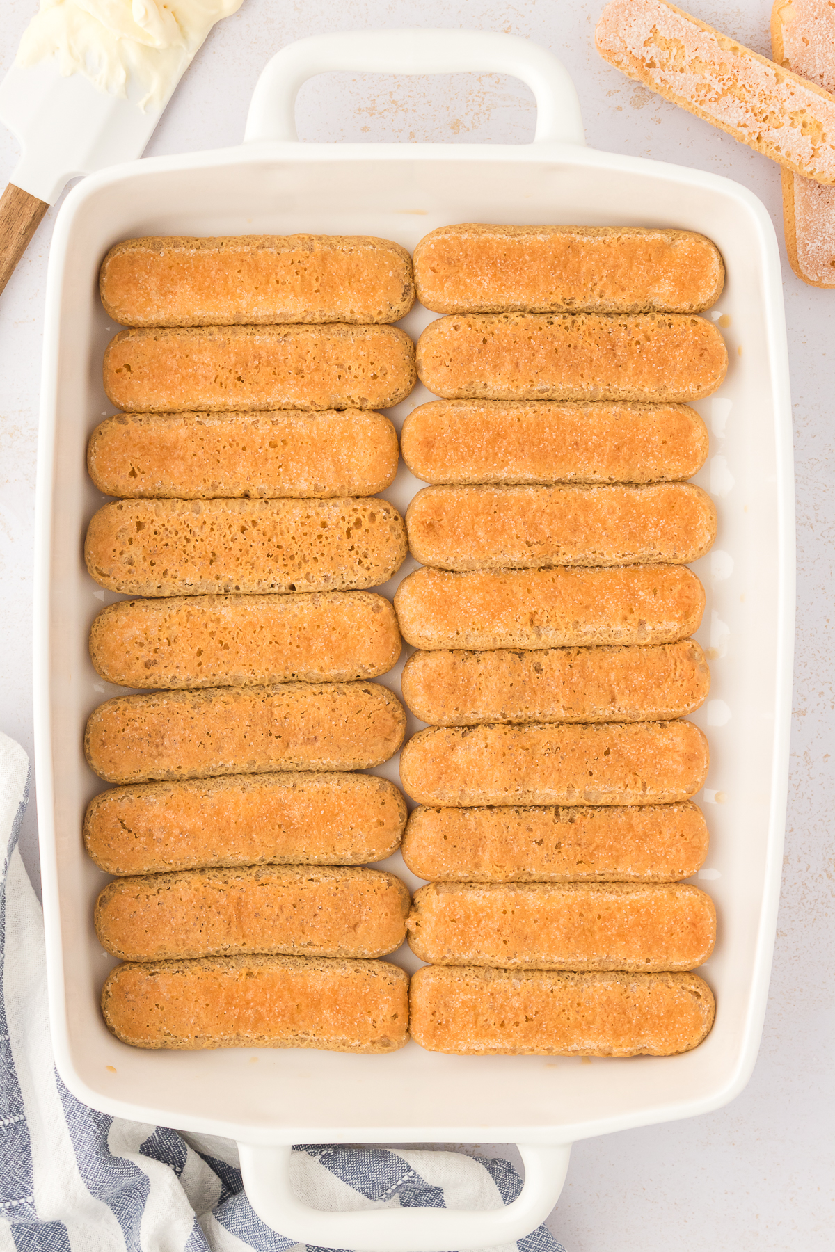 ladyfingers arranged in bottom of baking dish