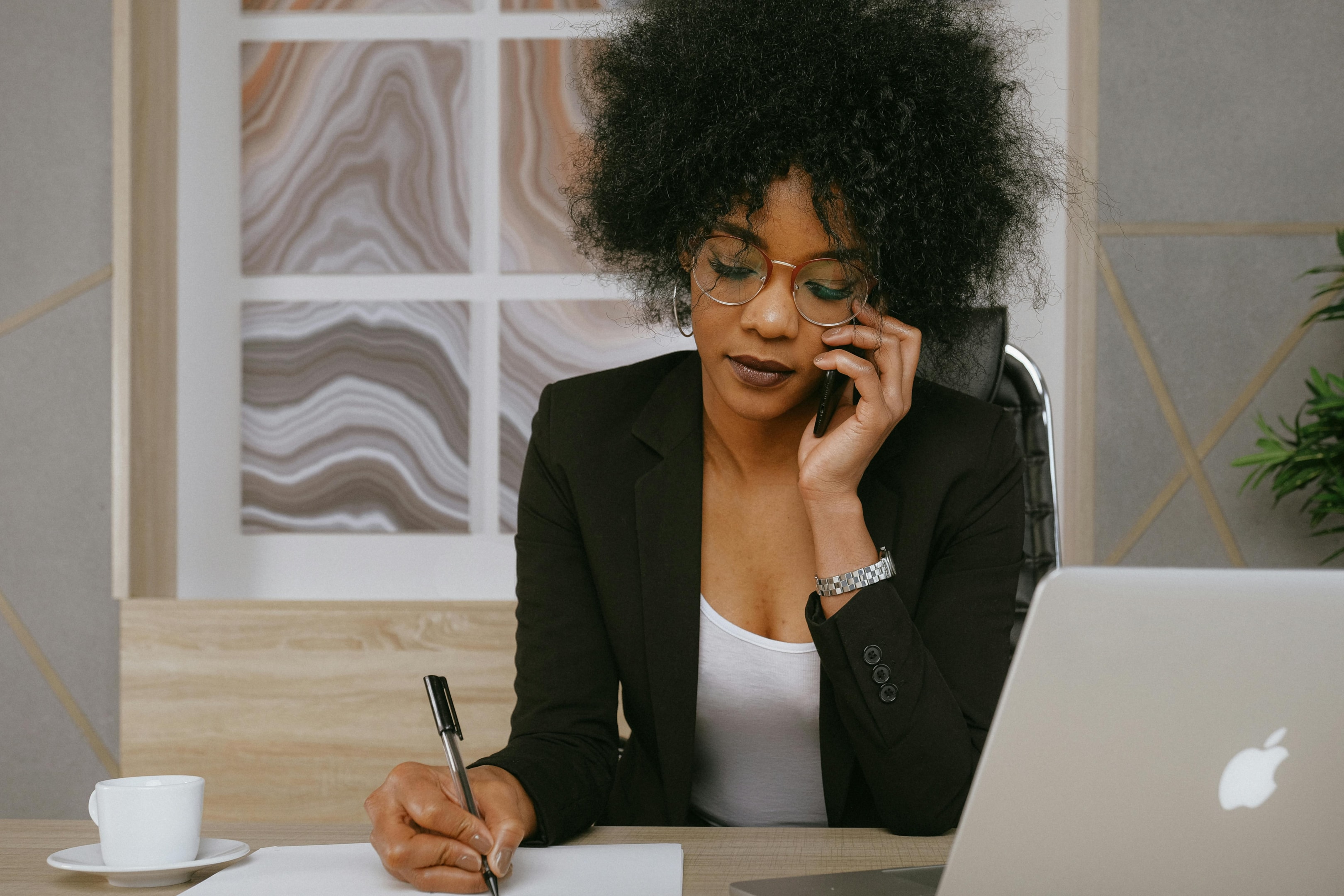 Real estate investor takes notes during a cold call with a motivated seller. 