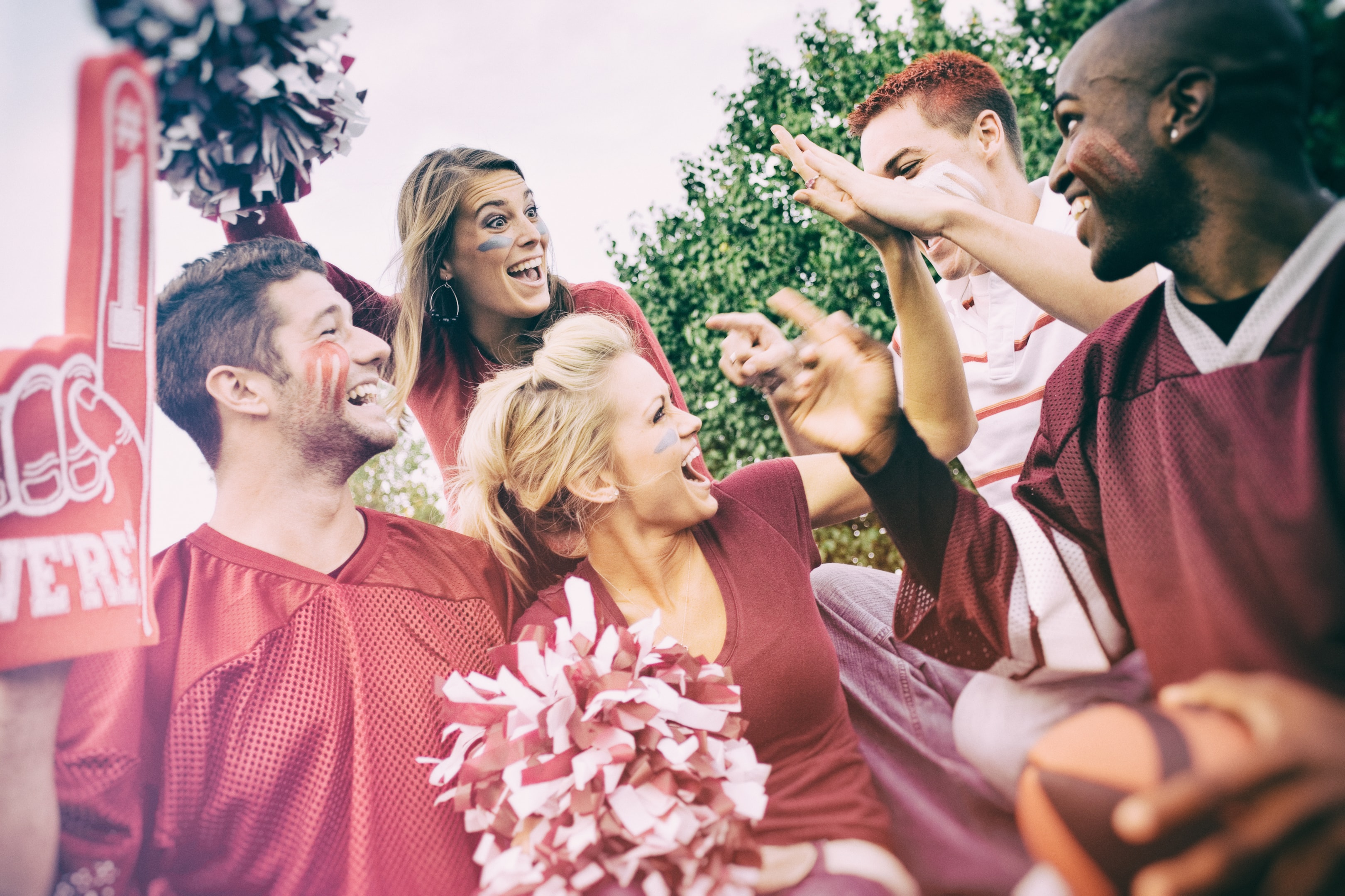 a group of enthusiastic sports fan cheering on their favourite team