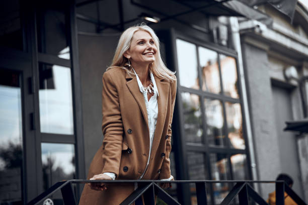 Older woman in style https://www.istockphoto.com/photo/gladsome-woman-at-the-banister-outdoors-stock-photo-gm1167044668-321715632