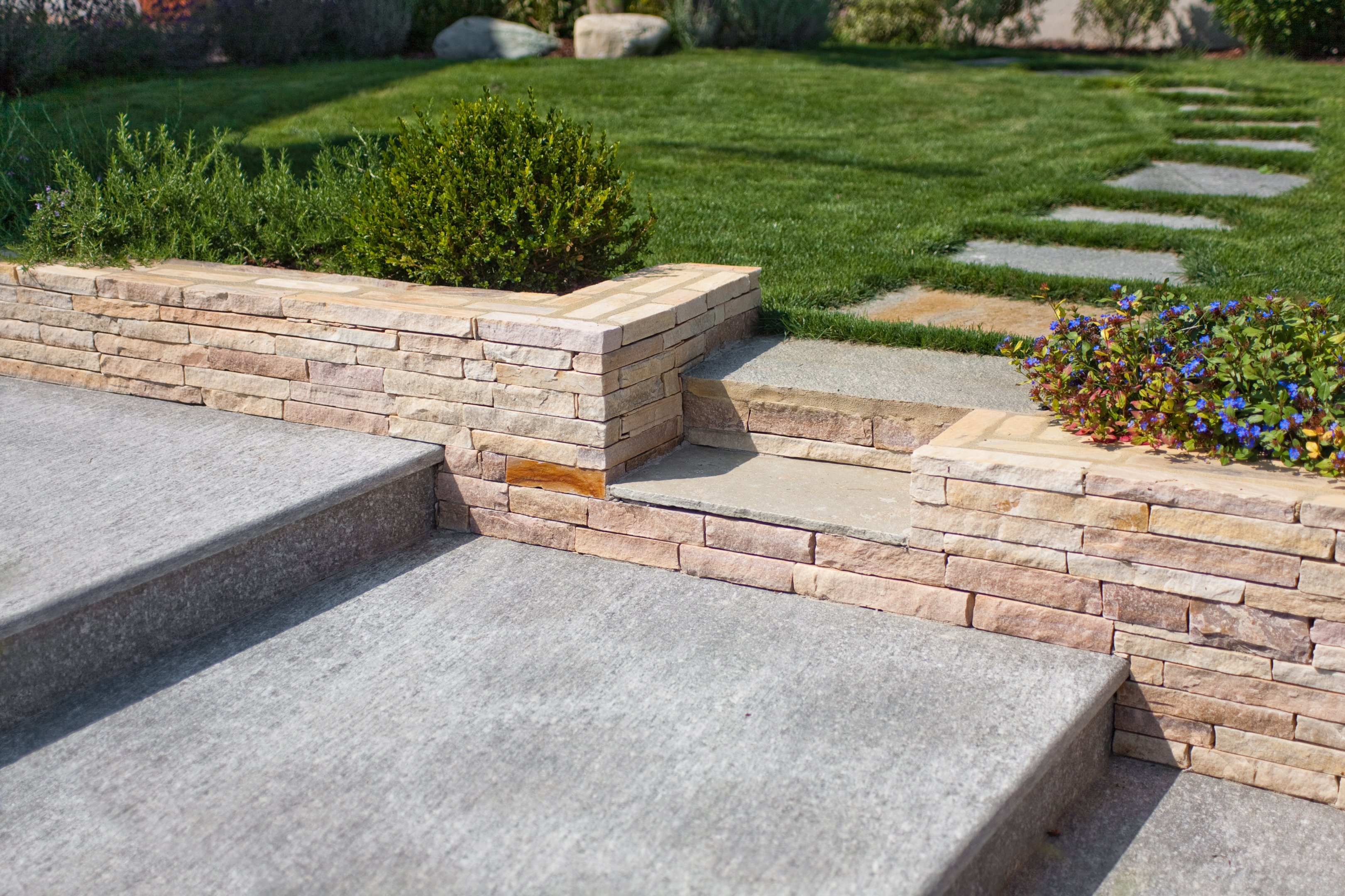 The stone separates the yard from the patio area