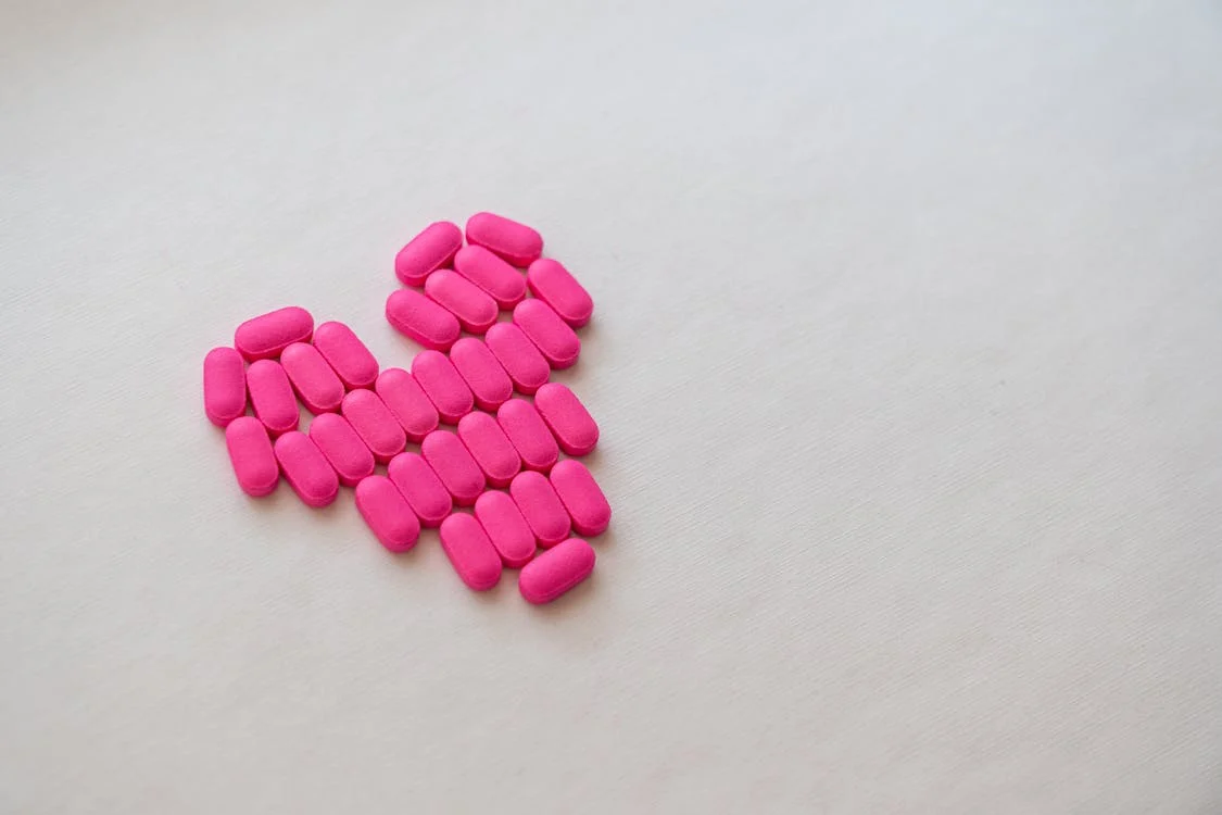 Free Pink Medication Pill on White Surface Stock Photo