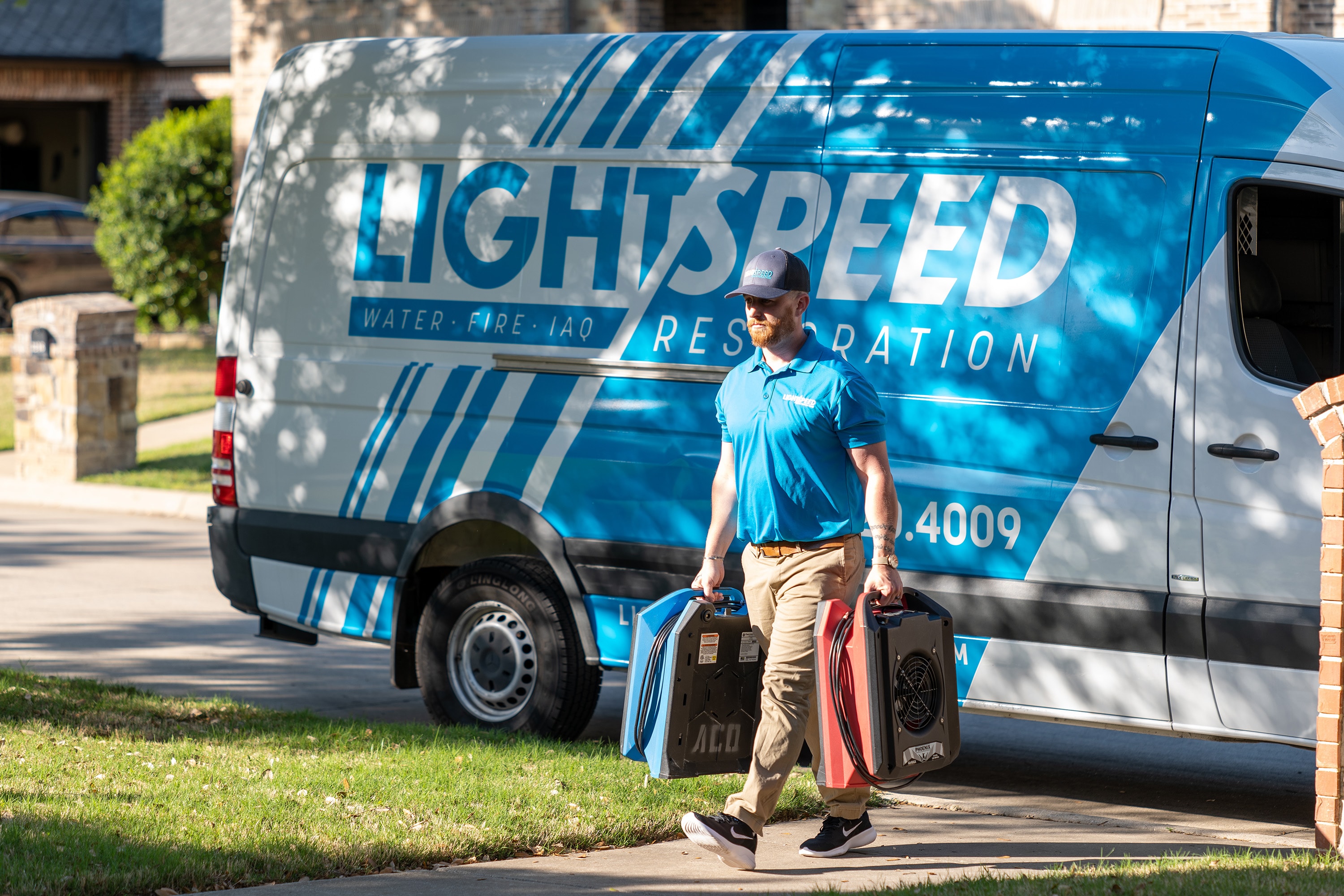 A restoration company van is parked in front of a residential home, ready to provide emergency water damage restoration services. The vehicle is equipped with advanced equipment for water extraction and mold remediation, ensuring a rapid response to mitigate further damage from water intrusion.