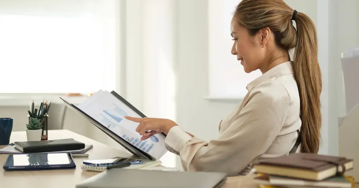 Self-employed woman preparing financial records for proof of income for self-employed applications.