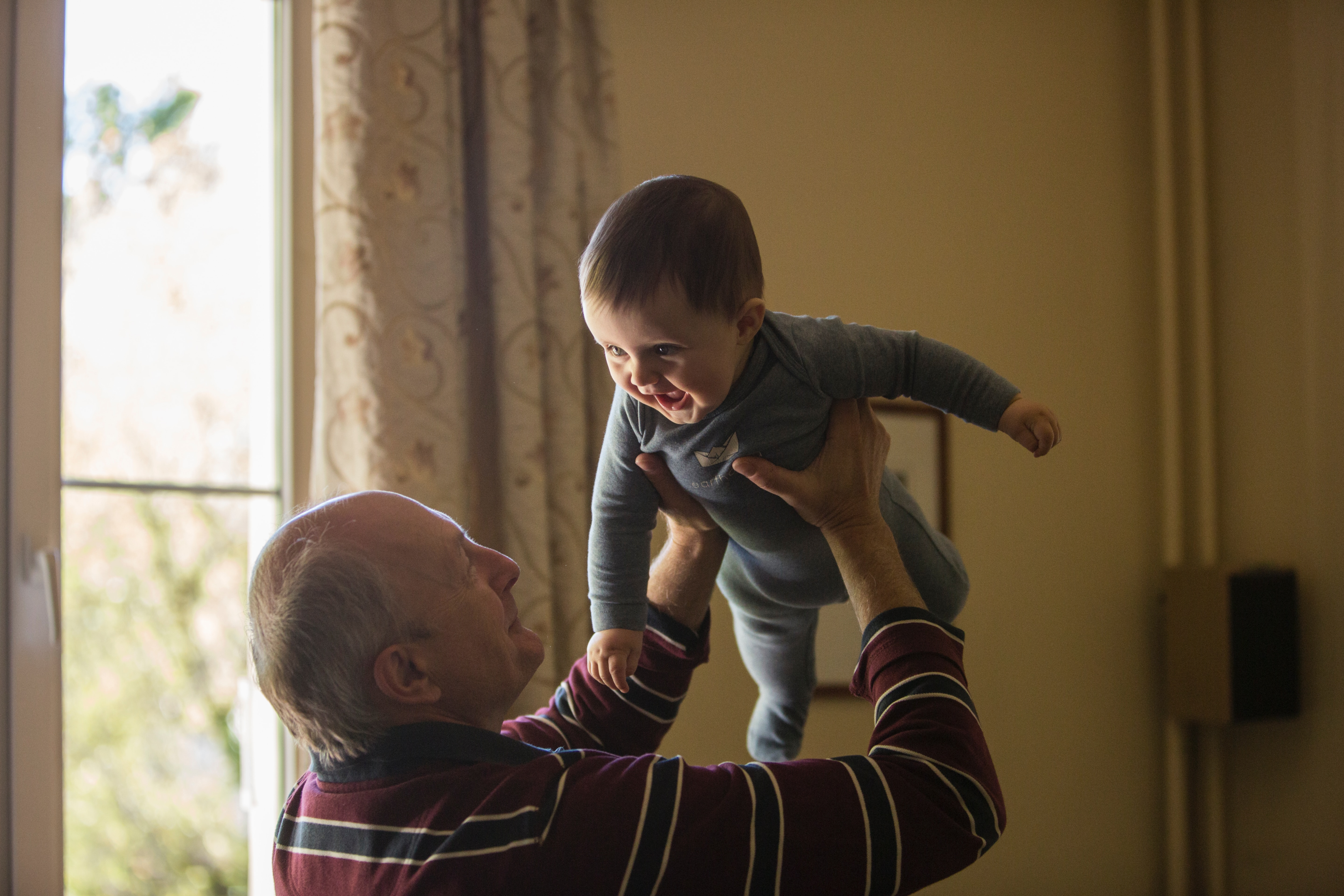 Grandfather holding grand baby boy