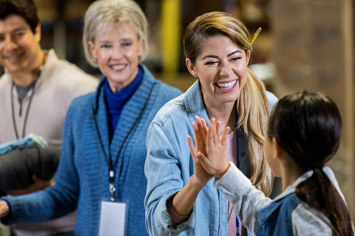 A women in philanthropy making a meaningful connection with a child.