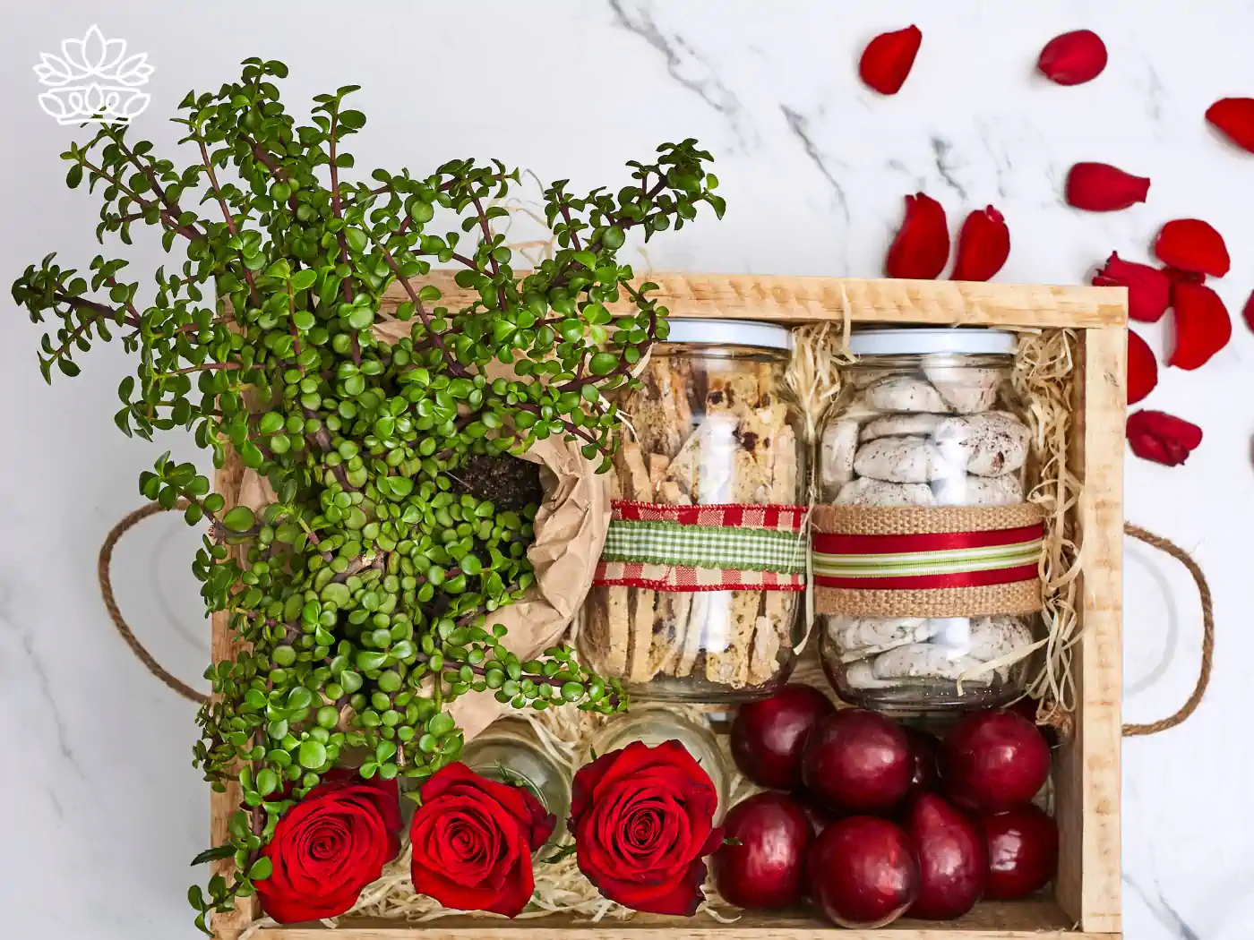 A beautifully arranged gift basket featuring vibrant red roses, fresh plums, a lush green potted plant, and jars filled with cookies and meringues, part of the mental health gift boxes by Fabulous Flowers and Gifts. Expertly assembled to bring joy and uplift spirits, delivered with heartfelt warmth and care.