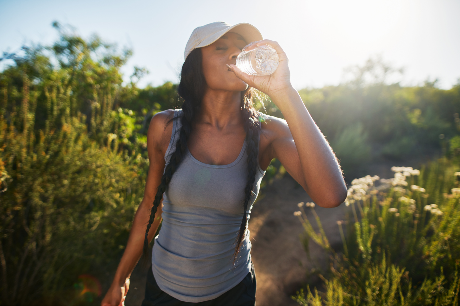 Woman drinking water during hike.