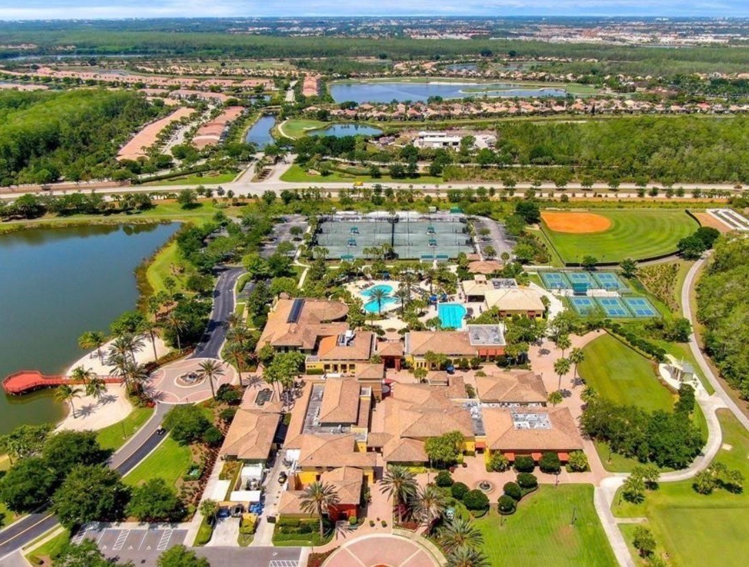 The image depicts a modern shopping plaza near Pelican Preserve, featuring lush palm trees and contemporary architectural designs. This vibrant community in Fort Myers, FL 33913, offers a welcoming atmosphere for residents and visitors alike.