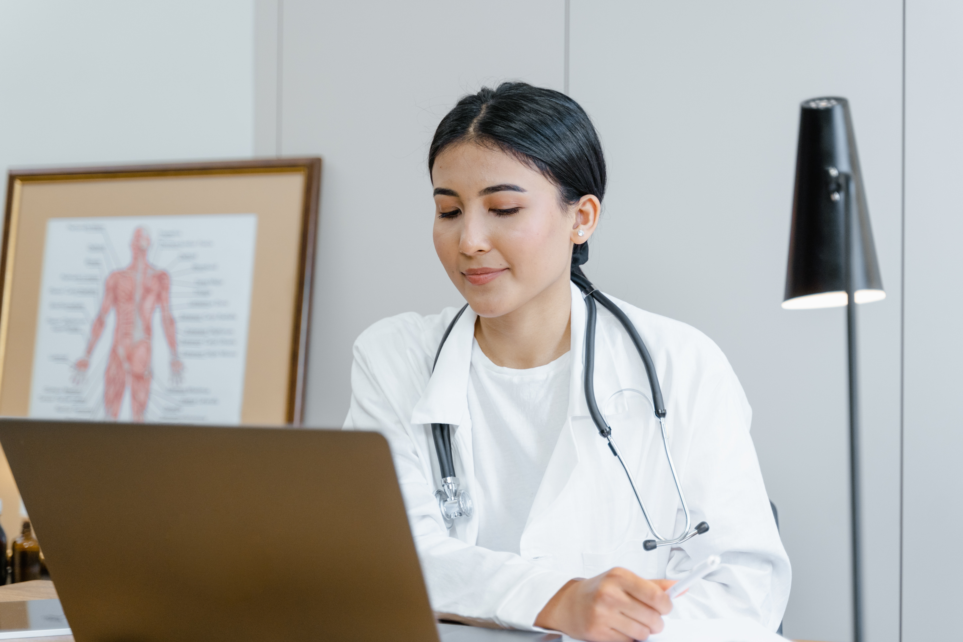 A doctor sitting in front of their computer.