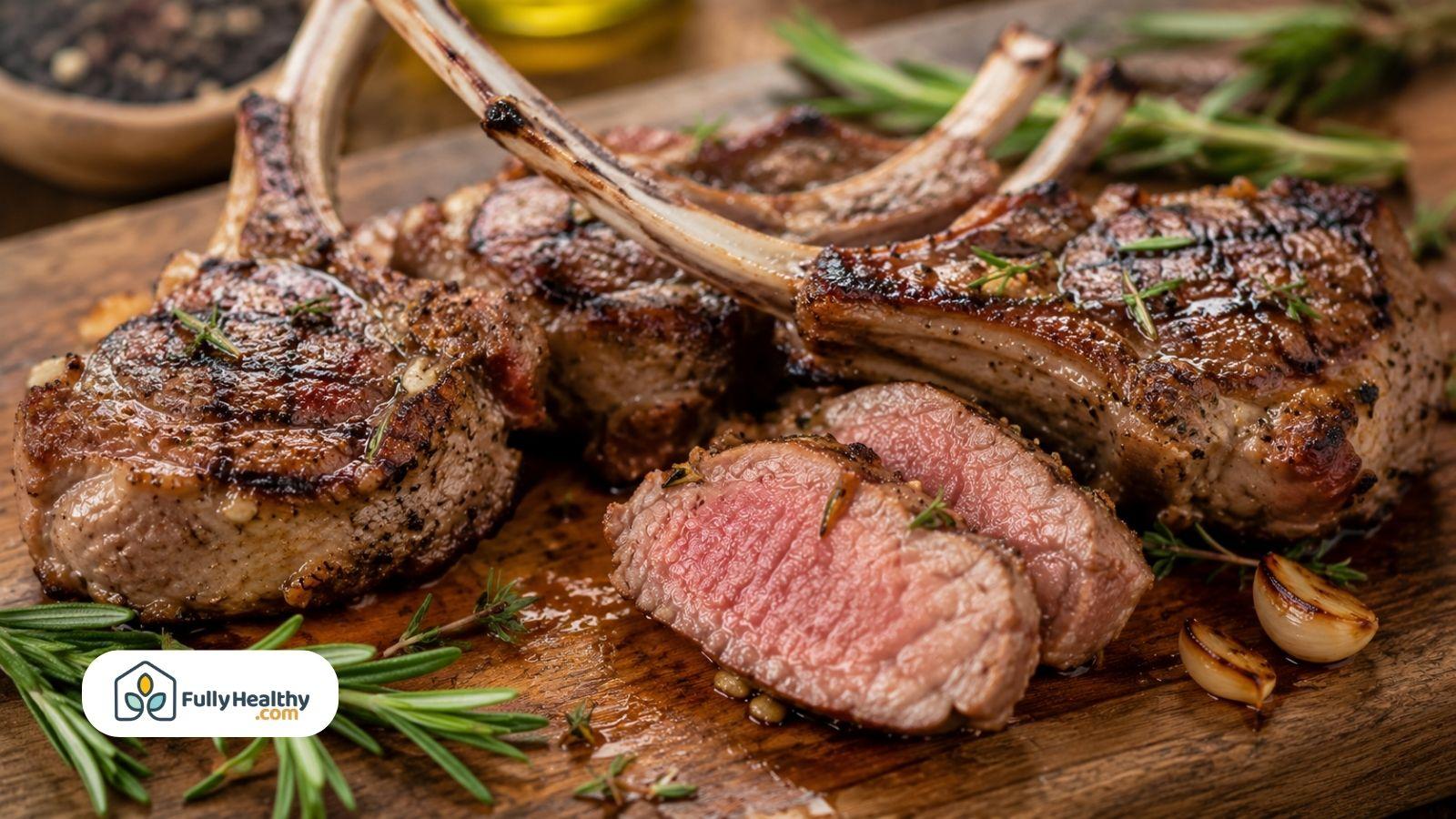 Medium-cooked lamb chops sliced open, showing juicy center with rosemary.