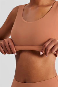 How do sports bras improve breast firmness and prevent sagging