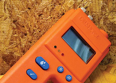 A Delmhorst moisture meter being used to measure the moisture content of wood and to identify moisture related problems