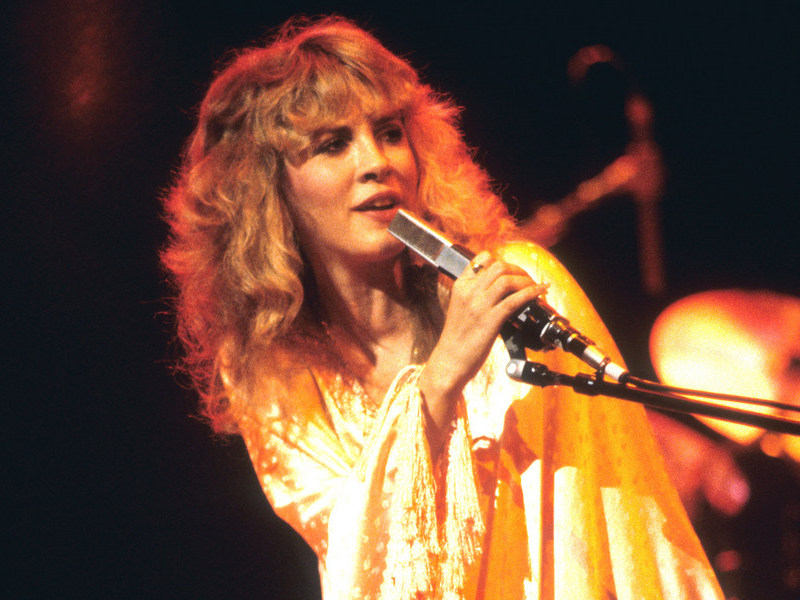 Young Stevie Nicks performing at a concert.