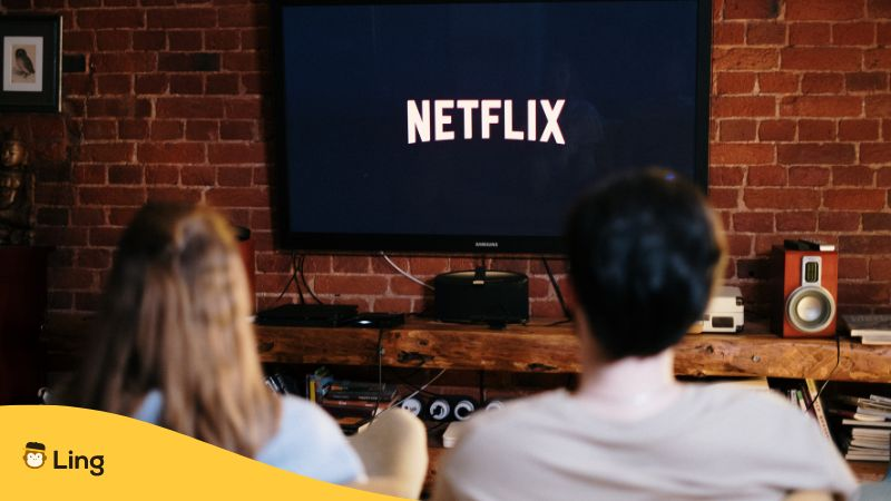 A man and woman watching on Netflix using a television