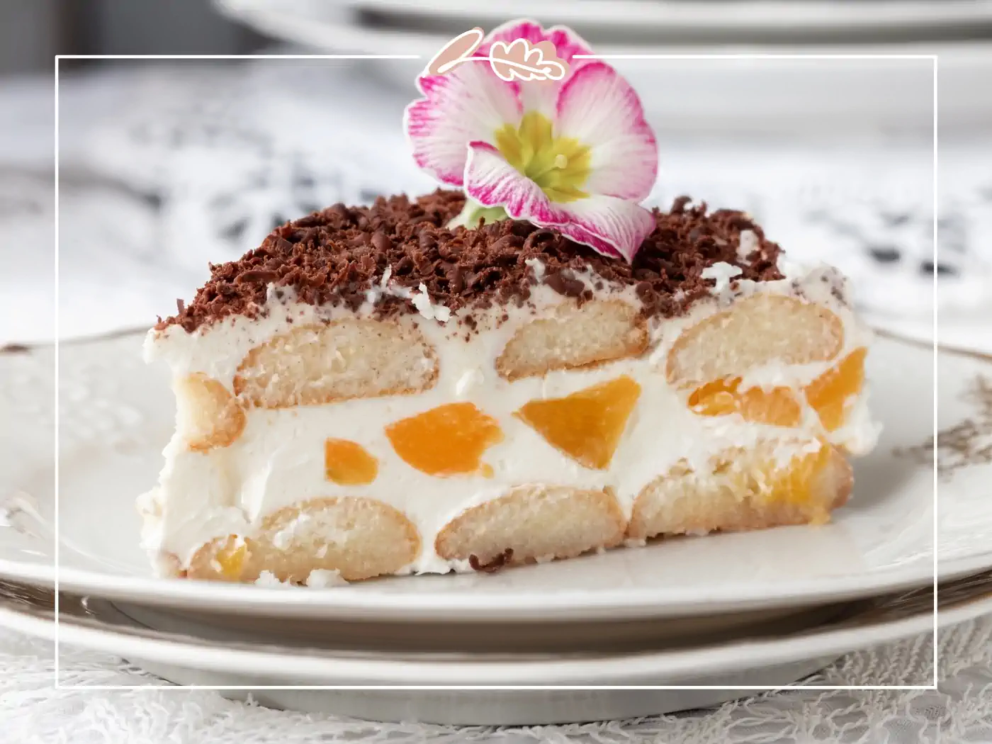 Slice of dessert topped with chocolate shavings and an edible flower. Fabulous Flowers and Gifts.
