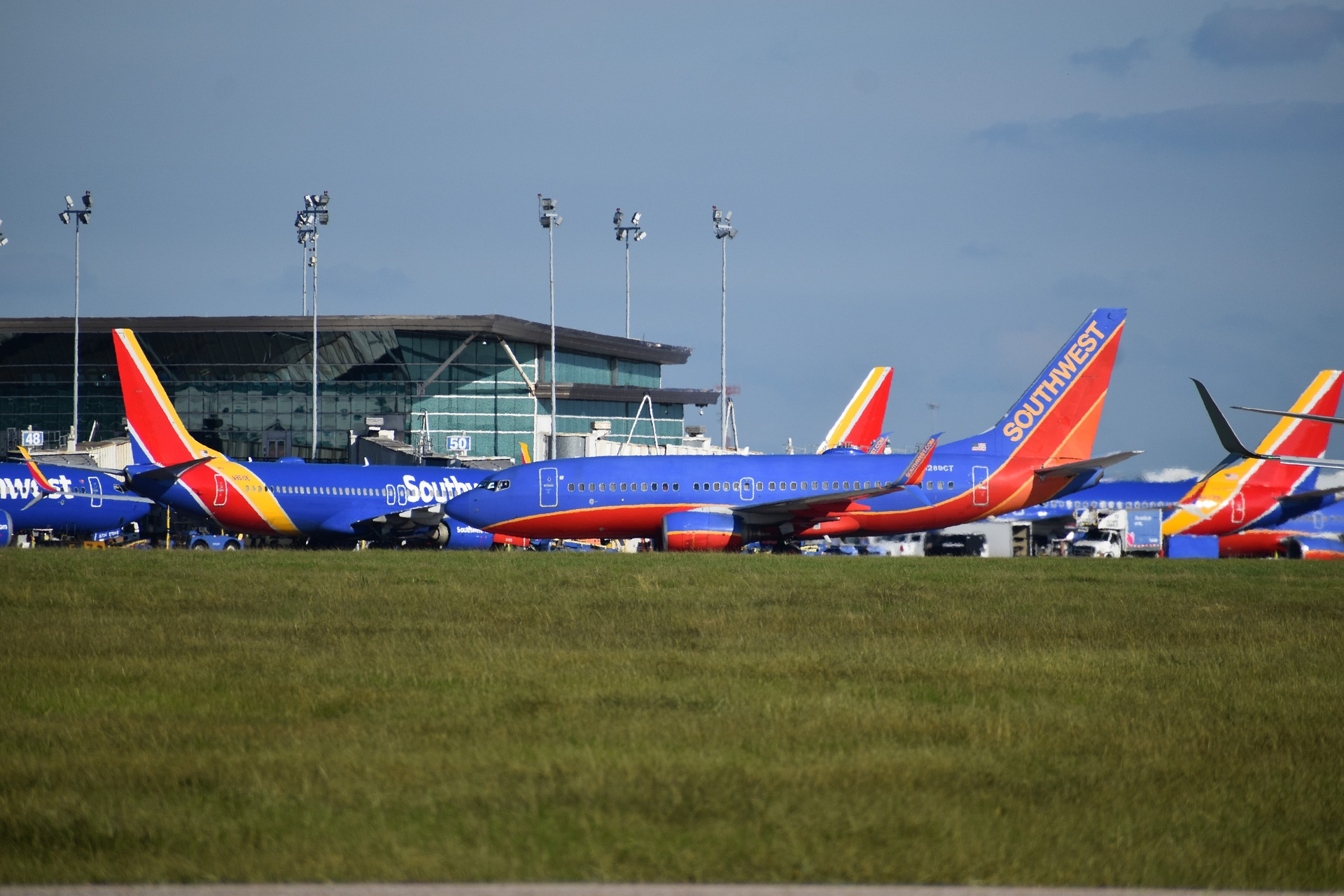 Southwest airline fleet parked by an airport terminal.