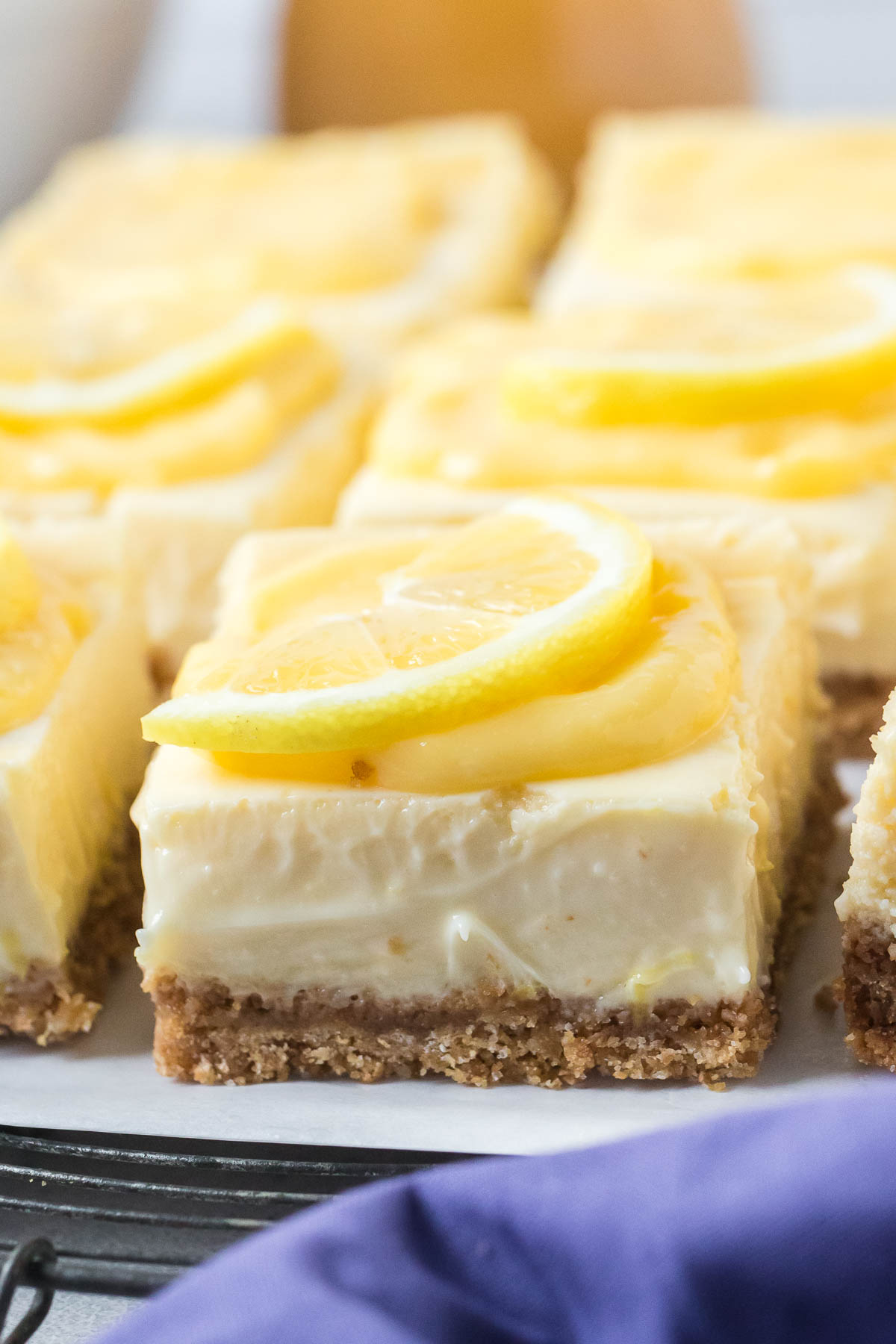 lemon cheesecake bars topped with fresh lemon slices
