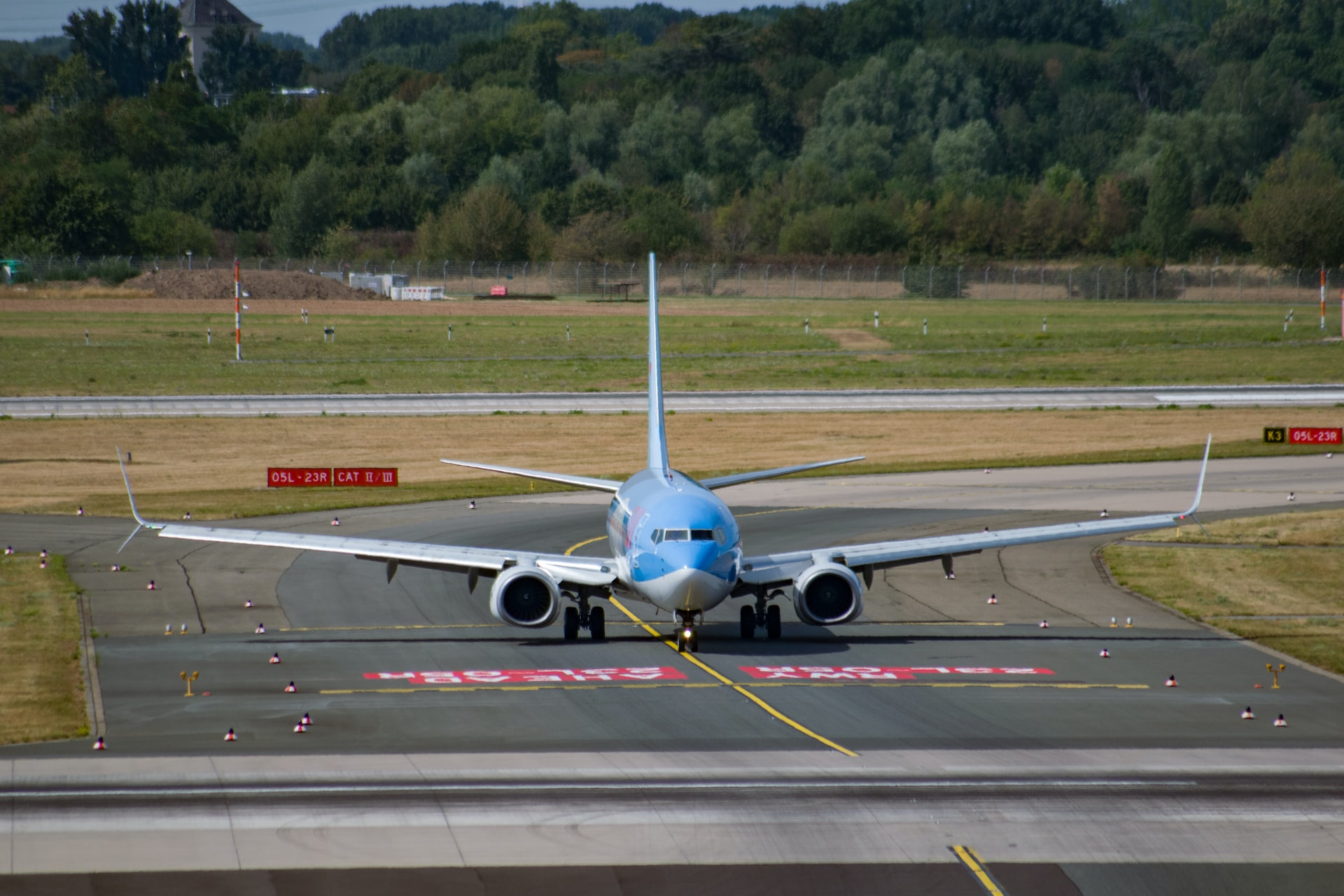 An aircraft passing hold short lines on the runway.