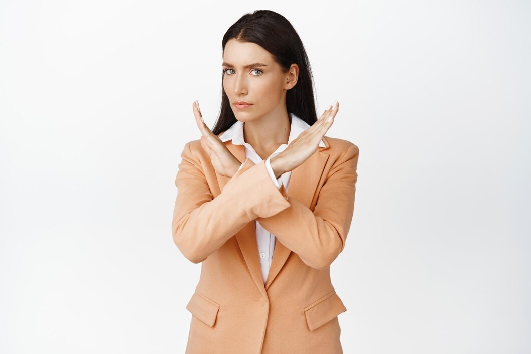 Woman with X gesture