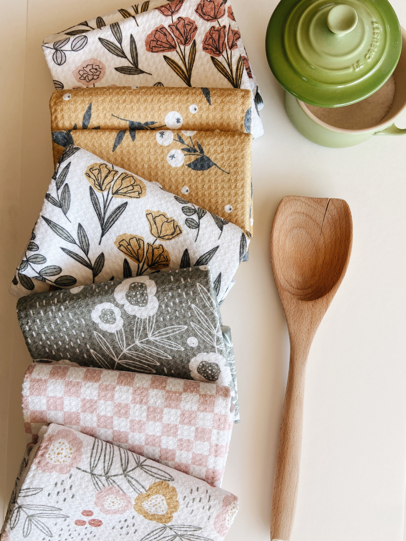 A stack of Geometry Tea Towels in various spring patterns. 