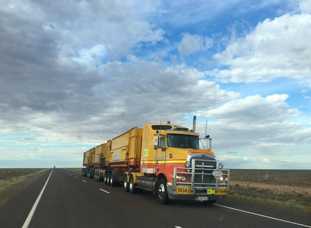 a heavy duty truck driving on the highway