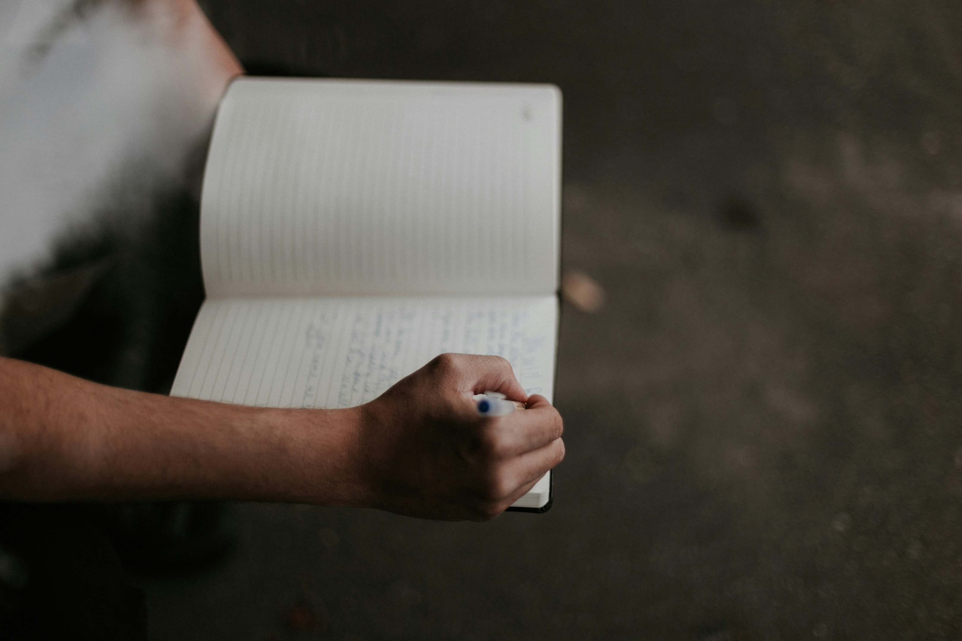 A person writing in a notebook.