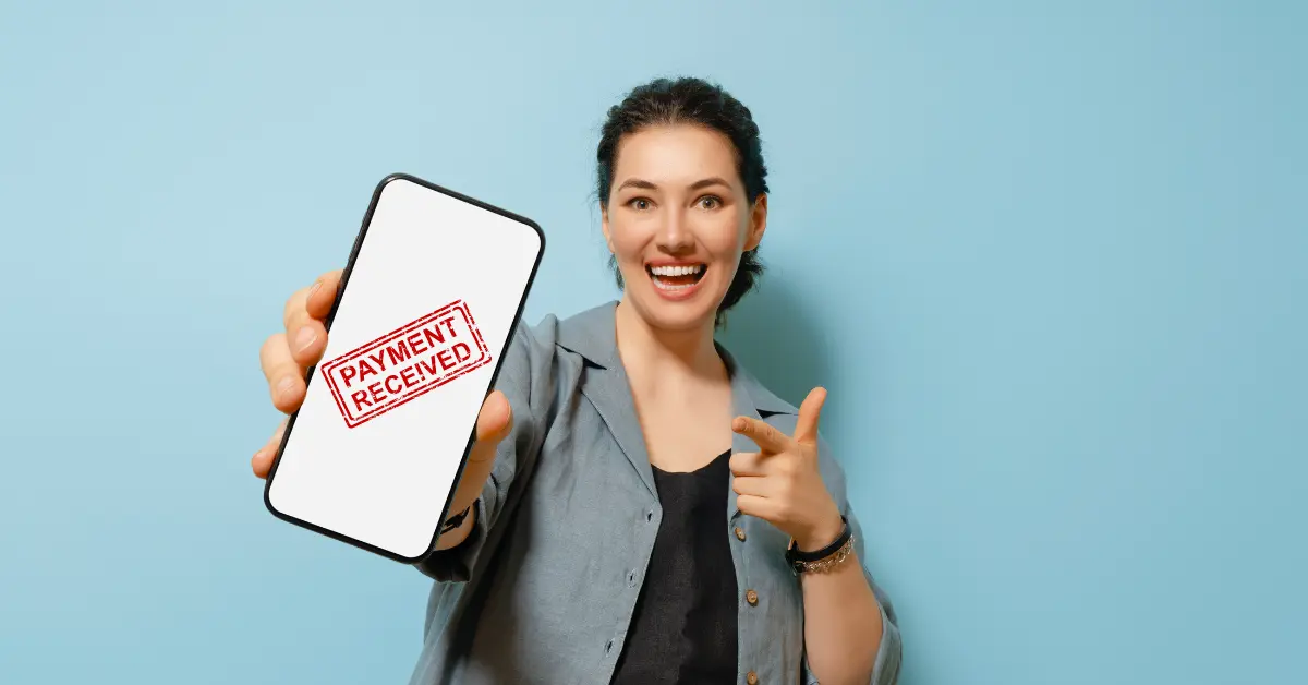 Visual of a payment received notification on a phone in hand, connected to how long does OnlyFans payout take.