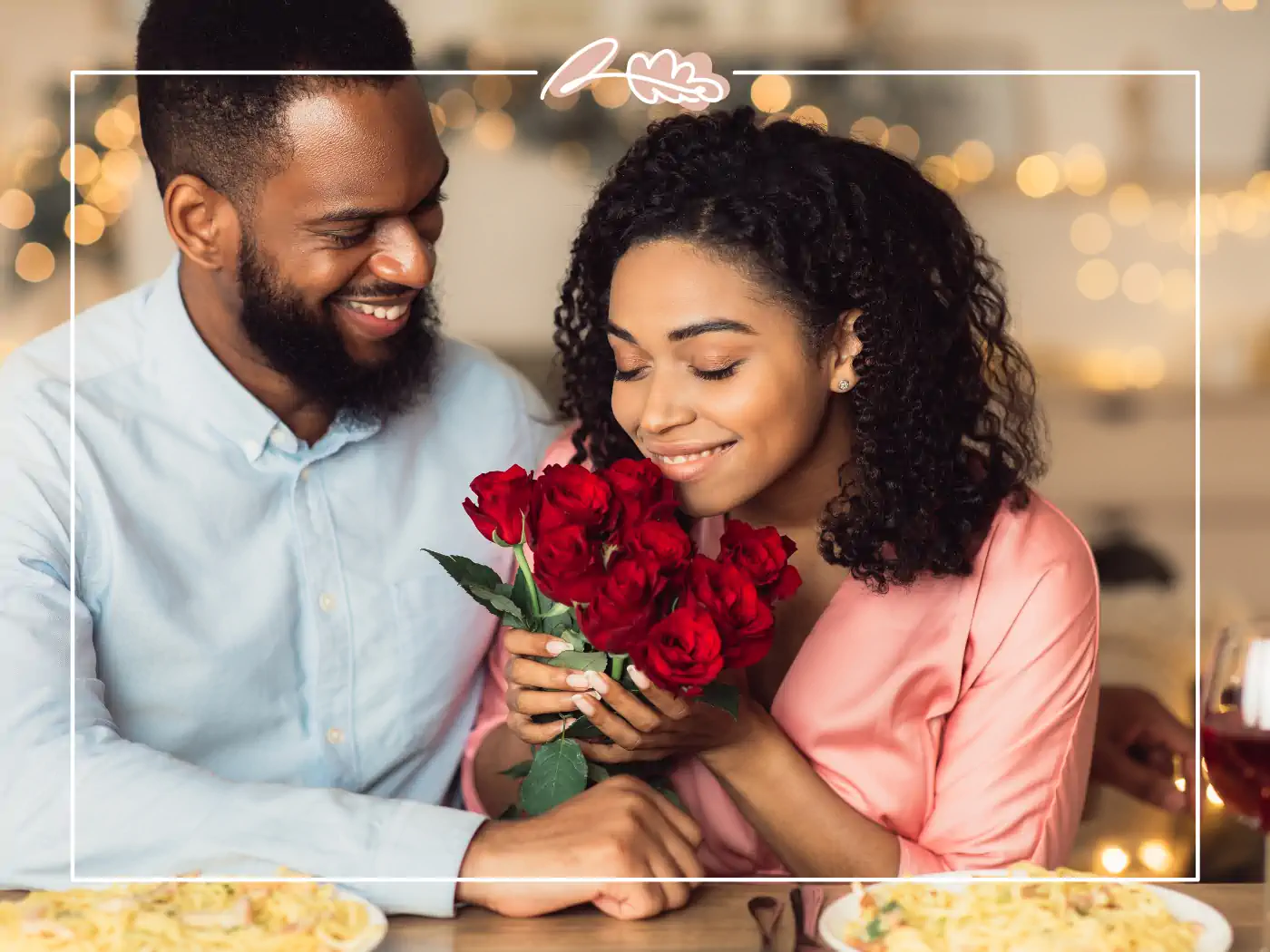 Couple at dinner with the woman holding a bouquet of red roses - Fabulous Flowers and gifts