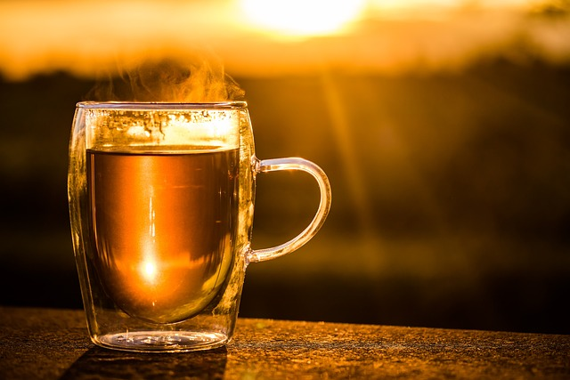 An image of a glass cup of steaming hot tea.