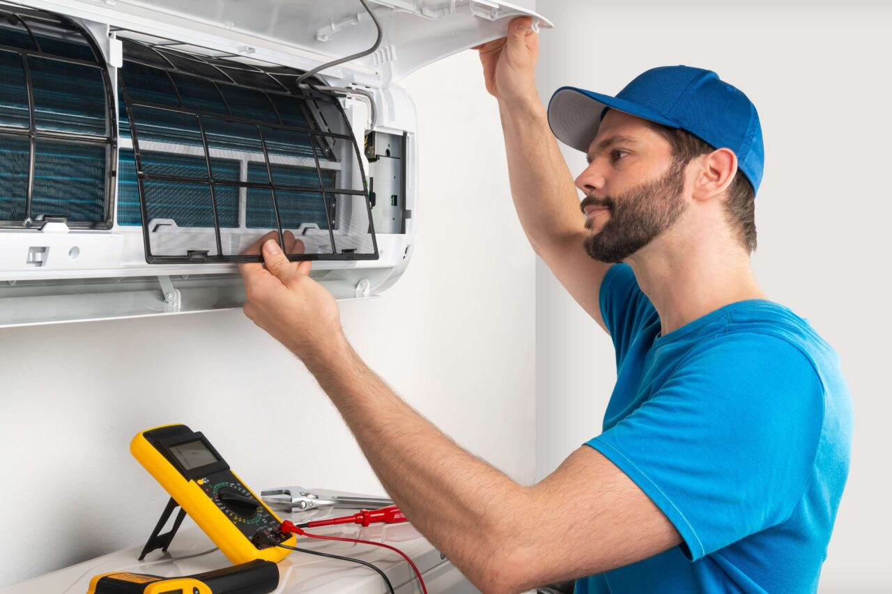 Technician fixing the Central ac in an office 