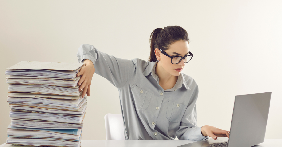 A woman reviewing financial documents, learning how to file taxes for OnlyFans as a self-employed creator.