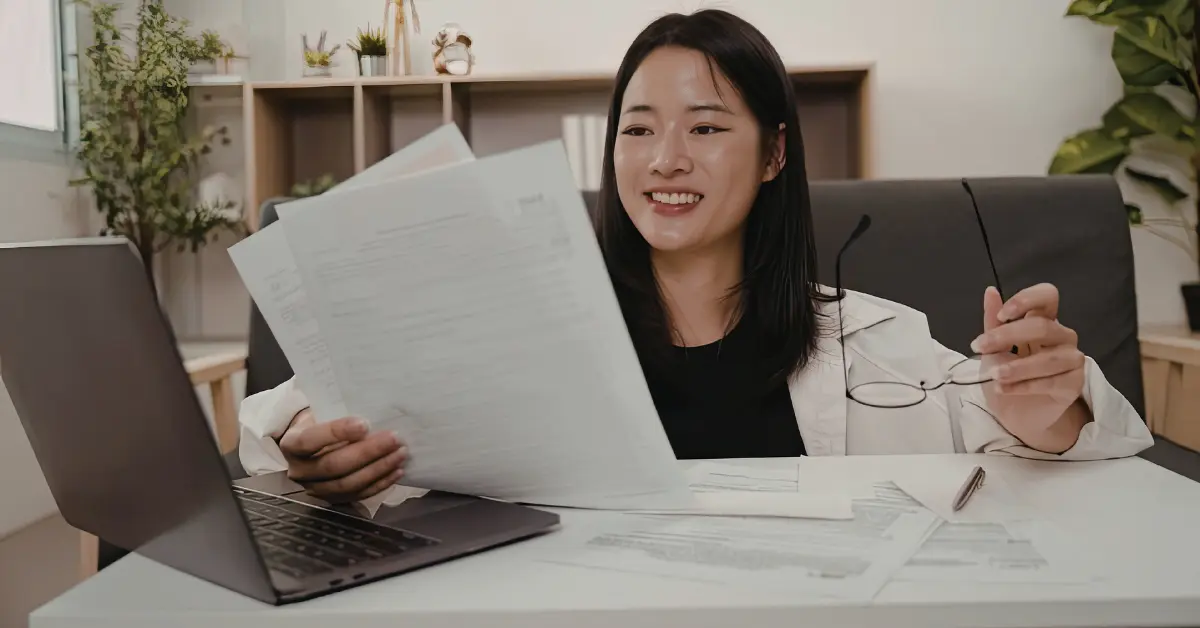 OnlyFans creator reviewing business documents while researching can an LLC own an S Corp.