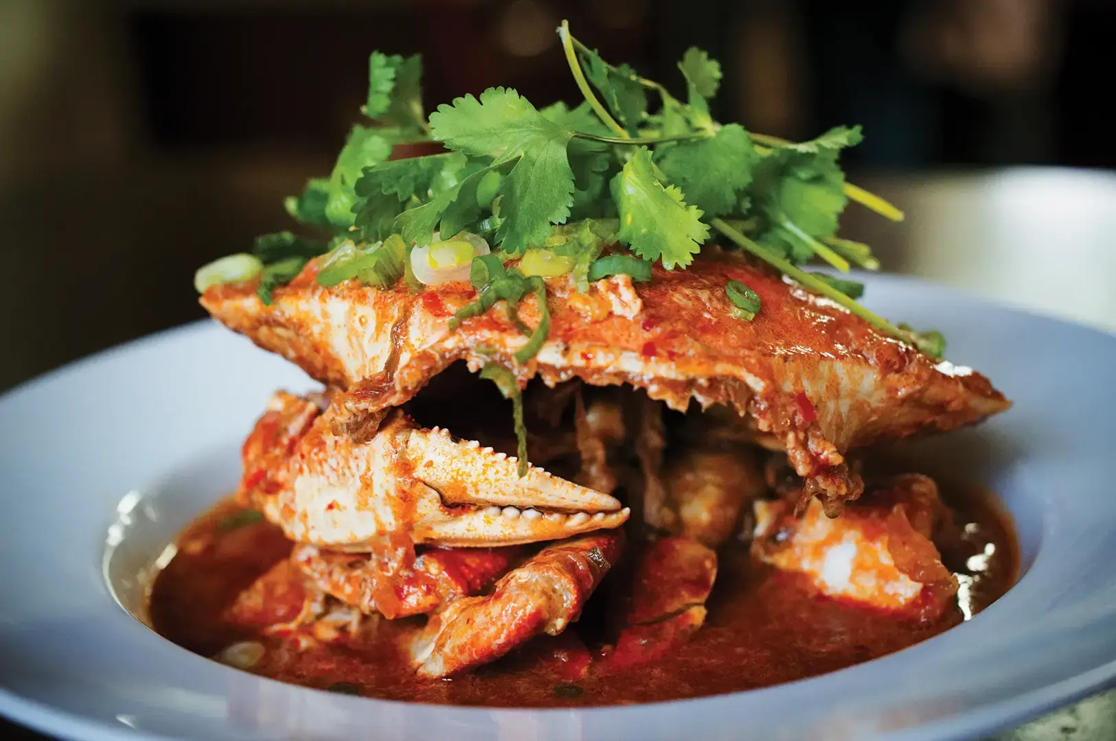 Singapore-style crab dish served in spicy tomato sauce with fresh herbs