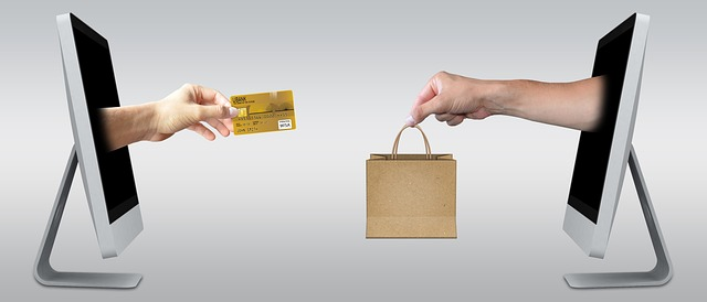 hands exchange a credit card and goods symbolizing the test buy program with targets counterfeit goods
