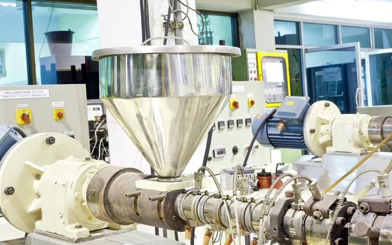 plastic extrusion process machine in manufacturing facility