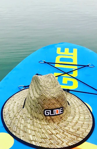 hat on a paddle board