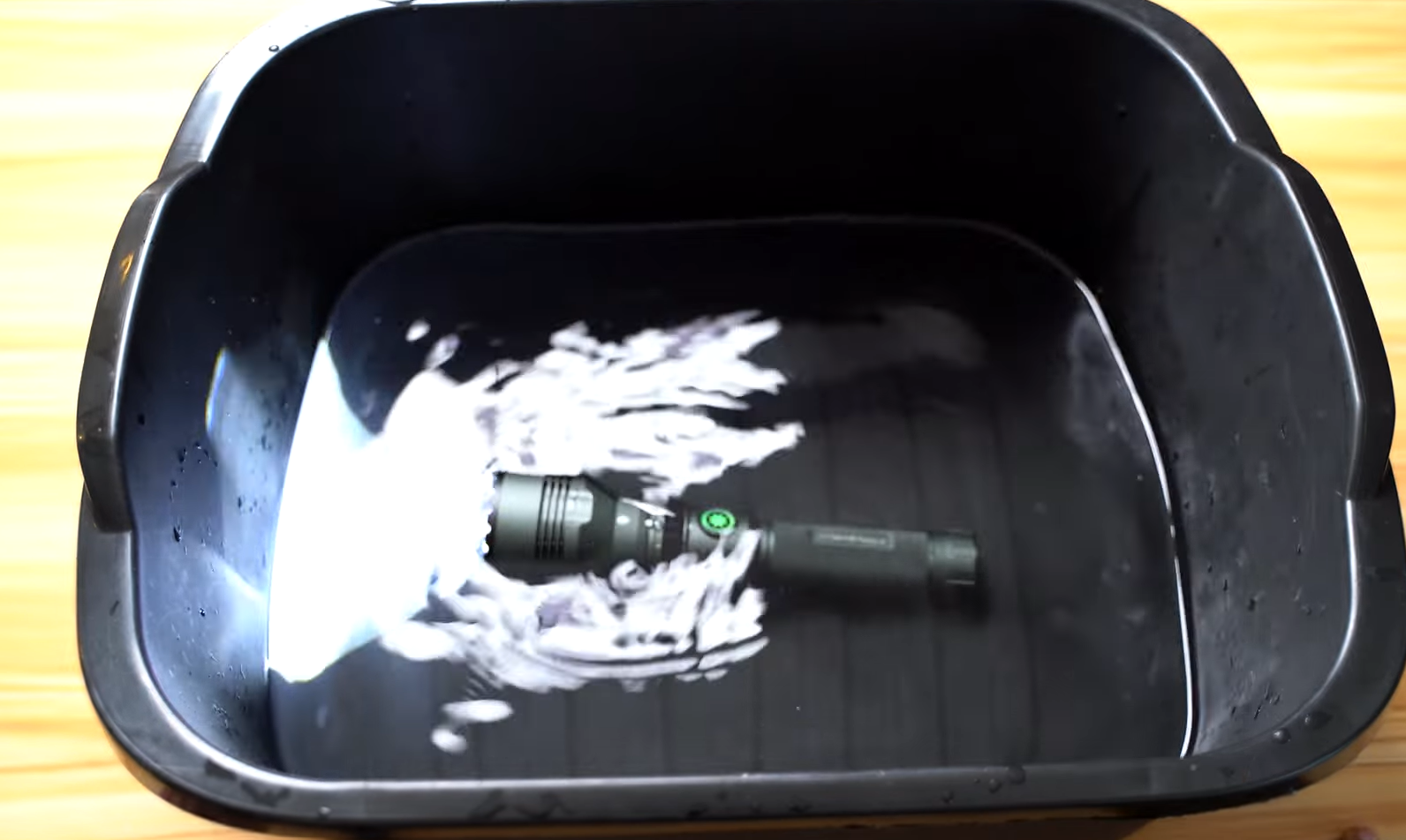 cyber tools survival flashlight dumped in a bowl of water